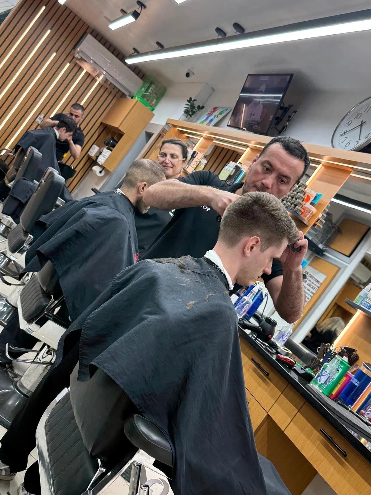 Barber giving a fresh haircut to a client at Barbershop 72