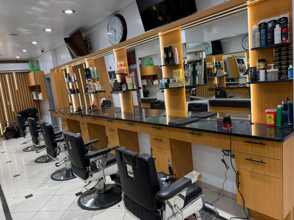 Wide interior view of Barbershop 72 styling stations and mirrors