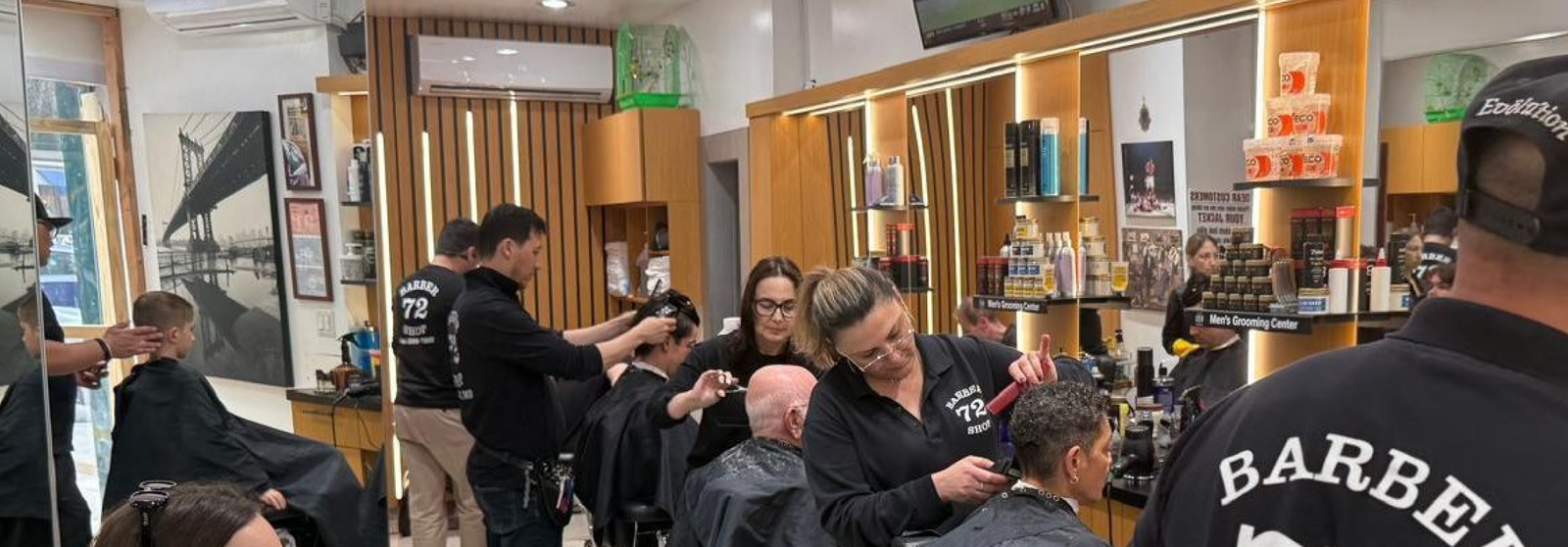 Busy Barbershop 72 interior with clients receiving professional haircuts